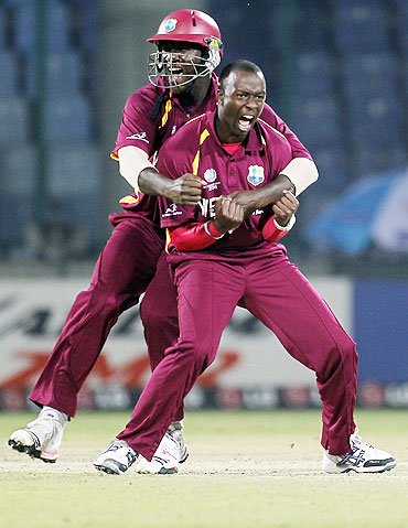 West Indies' Kemar Roach (right) celebrates with captain Darren Sammy