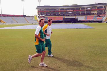 The pitch at the PCA stadium is covered as psychologist Henning Gericke and Andrew Hudson train during the South Africa team's practice session.