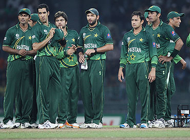 The Pakistan team await for a pending wicket appeal