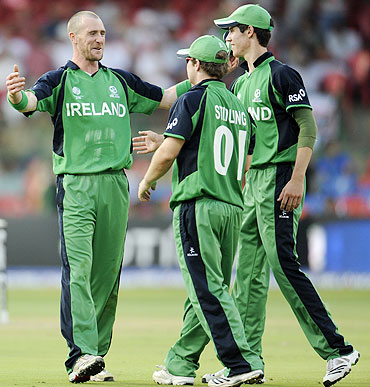 Ireland's John Mooney (left) celebrates with teammates after claiming the wicket of Jonathan Trott on Wednesday