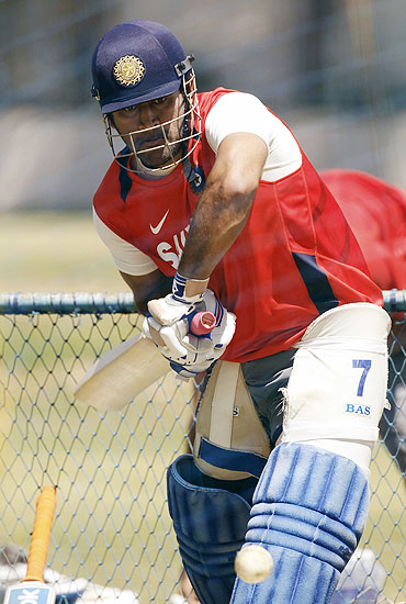 India's captain Mahendra Singh Dhoni hits a shot in the nets during a practice session in Bangalore on Saturday