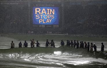 Ground staff at work as rain stops play in the Australia-Sri Lanka match