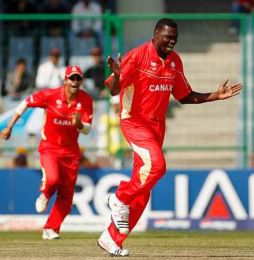 Canada's Henry Osinde celebrates after taking the wicket of David Obuya during the World Cup match