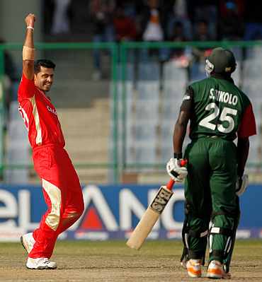 Canada's Rizwan Cheema celebrates after taking the wicket of Kenya's Steve Tikolo during their match
