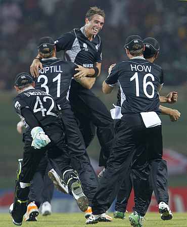 New Zealand Tim Southee celebrates with teammates after picking the wicket of Mohammad Hafeez