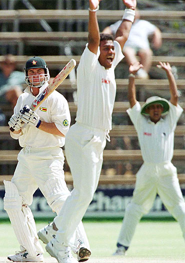 Sri Lankan bowler Ravindra Pushpakumara bowls to Zimbabwe's Alistair Campbell in a Test match in 1999