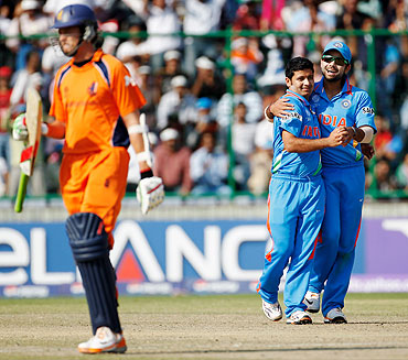 Piyush Chawla of India celebrates with team-mate Virat Kohli