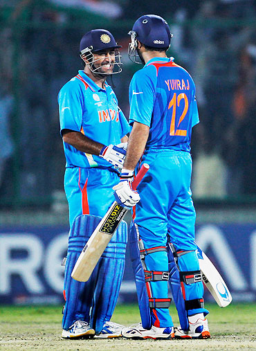India captain MS Dhoni (left) congratulates teammate Yuvraj Singh on scoring the winning runs against The Netherlands on Wednesday
