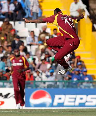 West Indies' Andre Russell celebrates after picking up Ireland's Ed Joyce