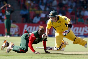 Australia's Brad Haddin and Kenya's Alex Obanda nearly collide during a run-out attempt
