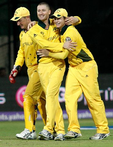 Michael Clarke (C) is congratulated by Steve Smith (R) and Brad Haddin after running out Mishra