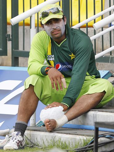 Umar Akmal puts ice on his foot during a practice session ahead of Monday's World Cup match against Zimbabwe
