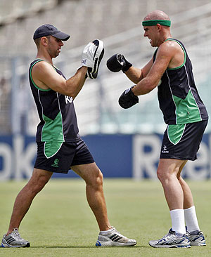 Ireland's Trent Johnston (right) boxes with the help of a staff member during a cricket practice session ahead of their Group B match against South Africa on Tuesday