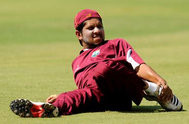 Ramnaresh Sarwan stretches during a training session
