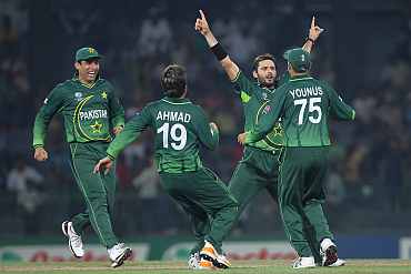 Pakistan's Shahid Afridi celebrates with teammates after picking up a wicket