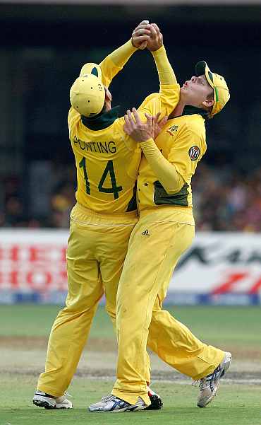 Ricky Ponting (R) of Australia collides with team mate Steven Smith as he takes a catch to dismiss Harvir Baidwan of Canada