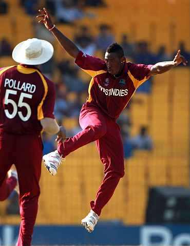 West Indies' Andre Russell celebrates taking the wicket of Ravi Bopara