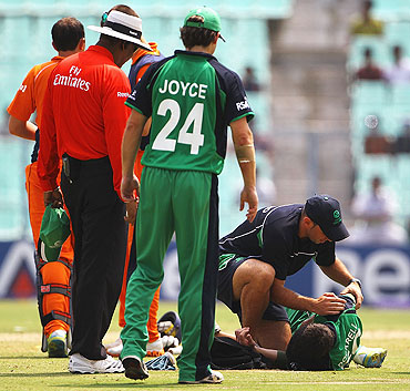 George Dockrell of Ireland receives treatment to his right shoulder during the match against The Netherlands on Friday