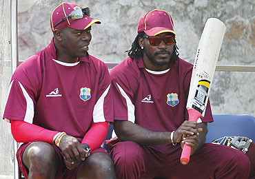 West Indies' Chris Gayle talks with coach Ottis Gibson (left)
