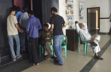 People queue up to enter a cinema hall in Karachi
