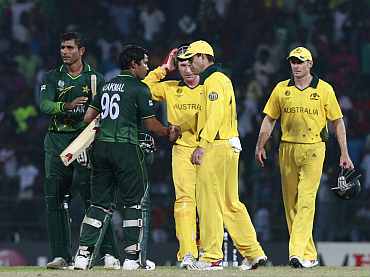 Umar Akmal is congratulated by Aussie players after the World Cup match in Colombo