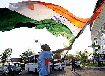 An India fan waves the national flag at the VCA stadium ahead of the match between India and SA