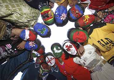 School children with their faces painted in the colours of national flags