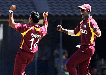 Ravi Rampaul (left) and captain Dareen Sammy celebrate after the dismissal of Sachin Tendulkar