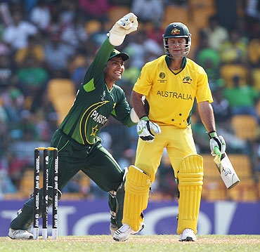 Ricky Ponting (right) is caught behind by Kamran Akmal off the bowling of Mohammad Hafeez