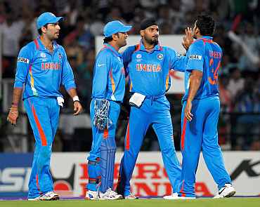 MS Dhoni celebrates after a fall of a wicket