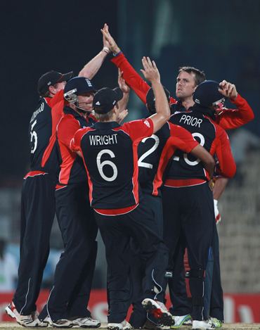 Graeme Swann is congratulated by teammates after claiming a wicket