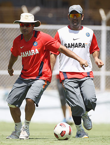 India's Sachin Tendulkar (left) and MS Dhoni (right) play football during a training session