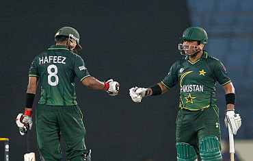 Pakistan openers Kamran Akmal and Mohammad Haffez celebrate after winning their match against West Indies