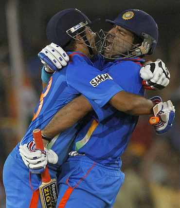 Yuvraj Singh and Suresh Raina celebrate after winning their quarter-final match against Australia