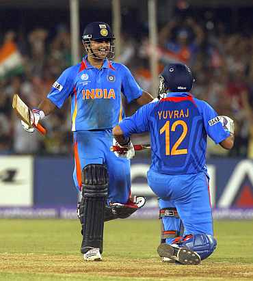 Suresh Raina celebrates with Yuvraj Singh after winning their quarter-final match against Australia