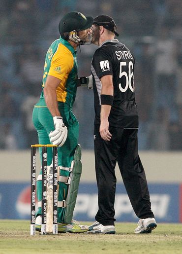 Faf du Plessis (L) of South Africa and New Zealand's Scott Styris pretend to kiss and make up after an altercation following the run-out of A B de Villiers