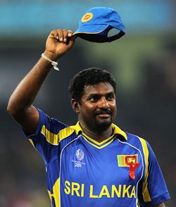 Muralitharan waves to the crowd after New Zealand's innings in the World Cup semi-final against Sri Lanka