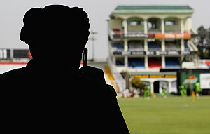 An armed policeman watches over the ground during a Pakistan nets session in Mohali 