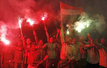 Fans in Ahmedabad celebrate India's victory over Pakistan
