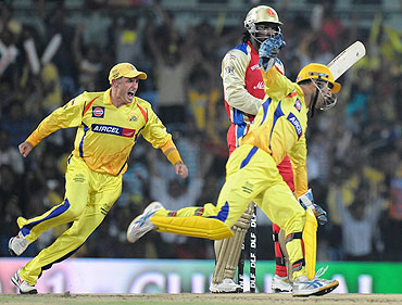 Chennai Super Kings captain MS Dhoni celebrates after the dismissal of Chris Gayle