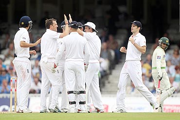 Graeme Swann (2nd from left) of England celebrates the wicket of Salman Butt