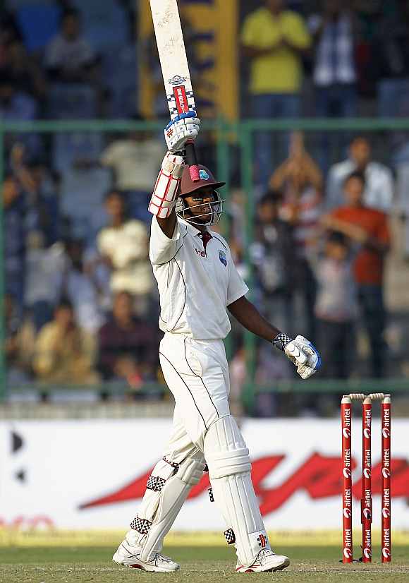 Shivnarine Chanderpaul celebrates after completing his century against India at Feroz Shah Kotla