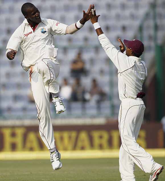 West Indies' Darren Sammy celebrates with Chanderpaul after picking up a wicket