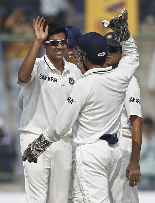 Ashwin gets a high-five from skipper M S Dhoni