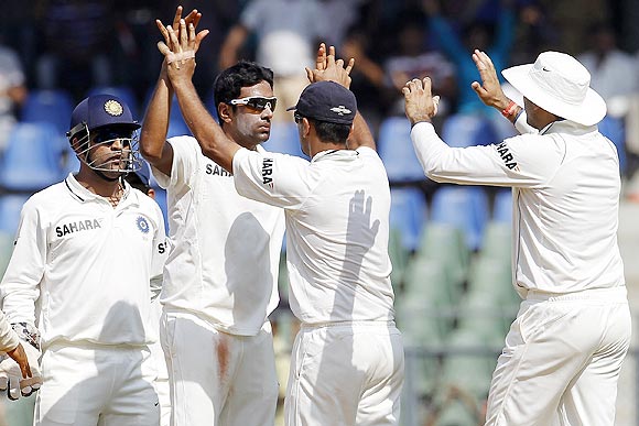 Ravichandran Ashwin (centre) celebrates with teammates after dismissing Barath