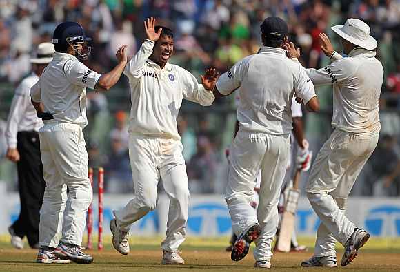 Pragyan Ojha celebrates after picking up a wicket