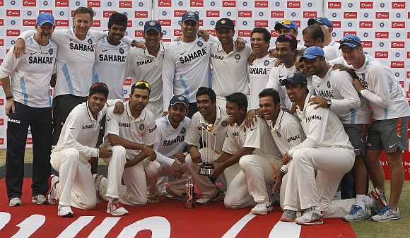 Indian team pose for photographers with the winners trophy
