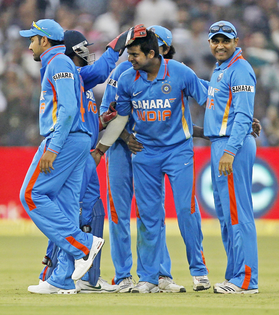India's Suresh Raina (center) celebrates with teammates after taking the wicket of West Indies' Darren Bravo
