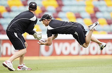 New Zealand's Brendon McCullum (right) takes a catch during a fielding session ahead their first Test match against Australia