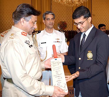 Former Pakistan President General Pervez Musharraf (left) recieves a bat with autographs of Indian players from former India captain Sourav Ganguly during a meeting in Islamabad on March 17, 2004